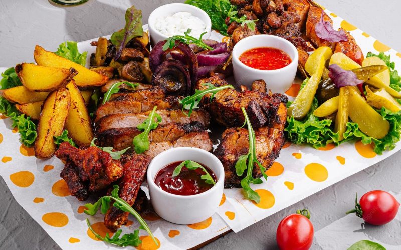 delicious-grilled-meat-assortment-with-sauces-potatoes